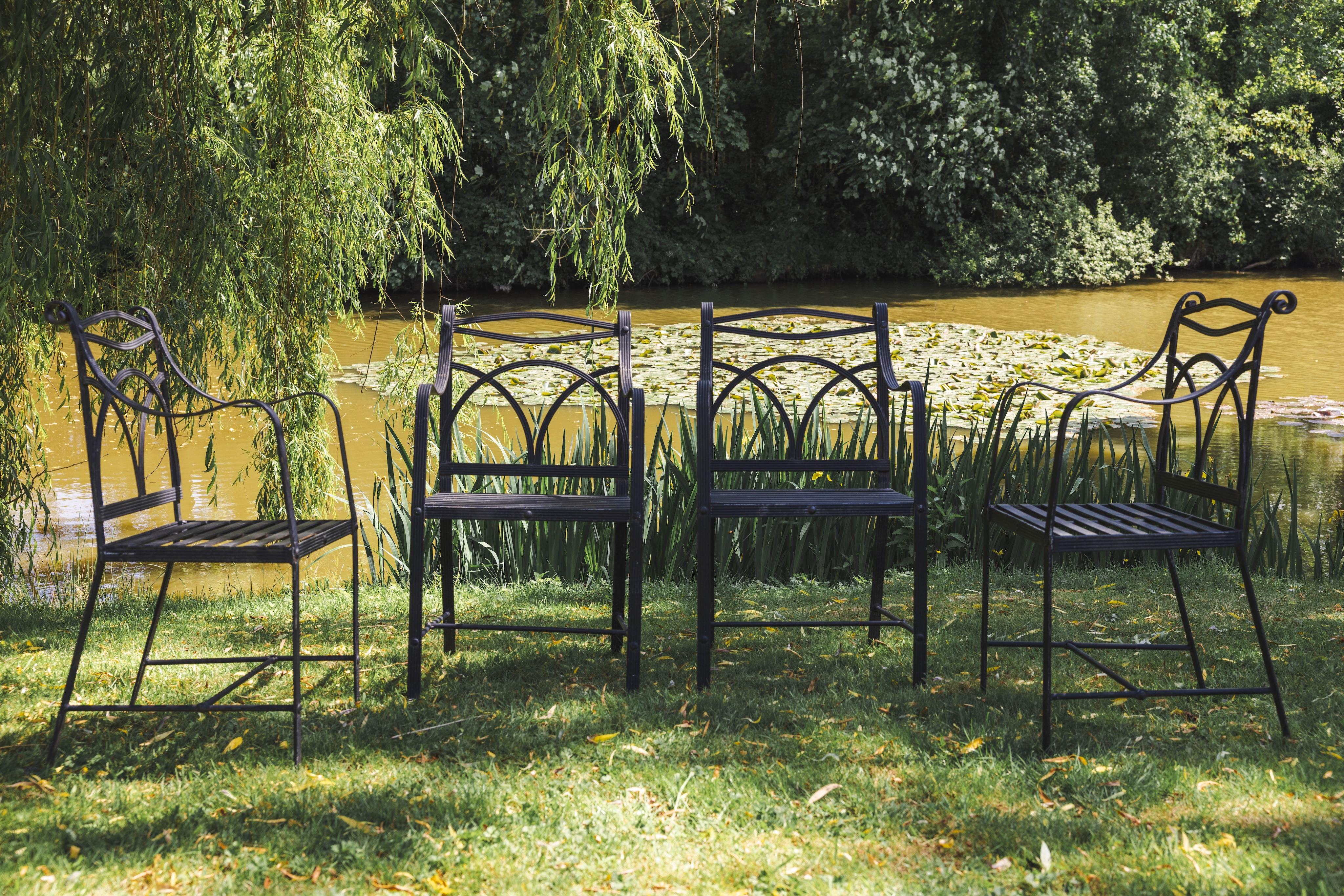 A set of four wrought iron garden chairs, width 53cm, depth 42cm, height 95cm